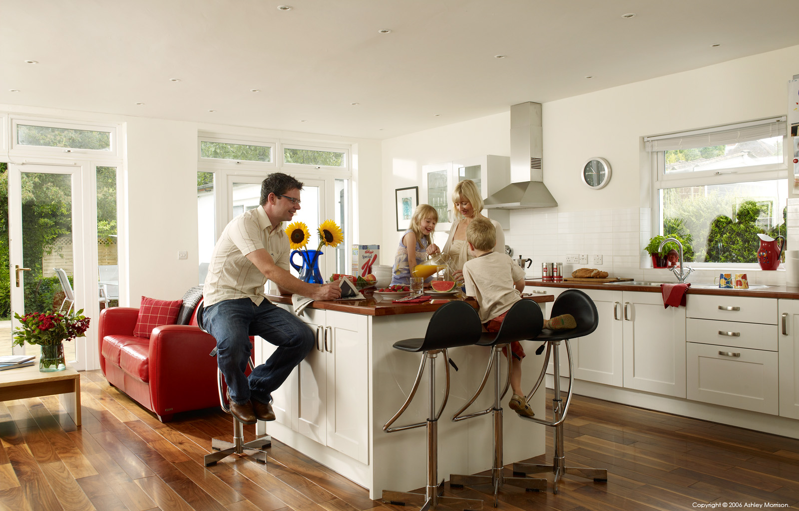 Jim & Helen Braden with their family in the kitchen of their detached 1930s home in Belfast by Ashley Morrison.