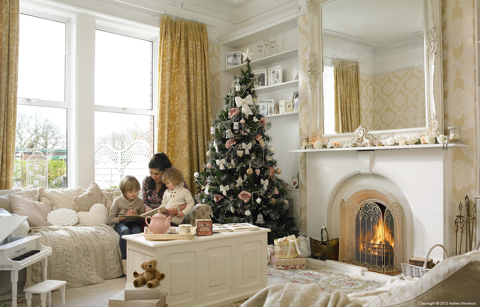 Amanda Cunningham with her two childern in the sitting room of their double fronted mid terrace house in Belfast at Christmas.