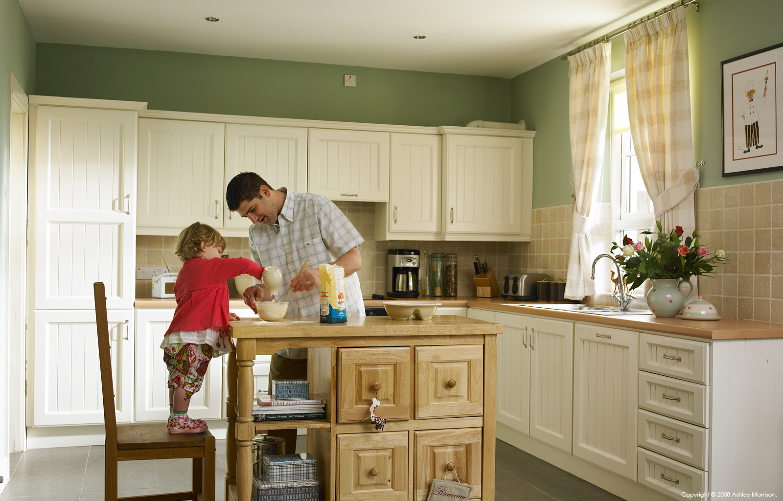 Matt King with his daughter in the kitchen of their home on the grounds of Castle Leslie in County Monaghan by Ashley Morrison.