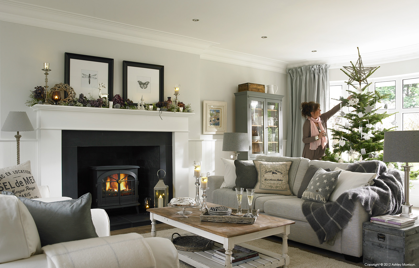 Marie McMillen adding the finishing touches to the Christmas tree in the sitting room of her renovated 1960's house near Holywood in County Down.