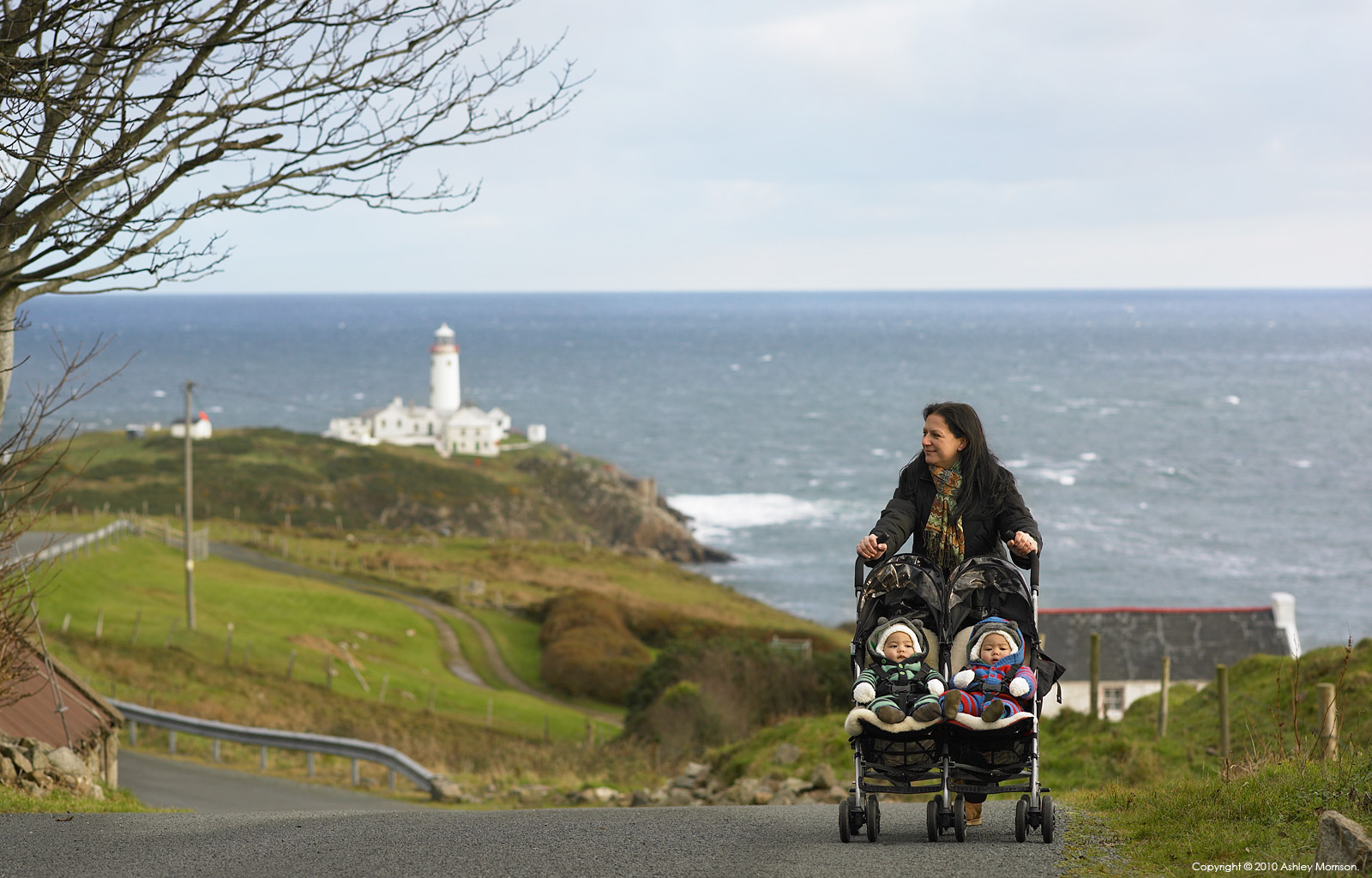 Sarah Mitchell with her twins walking outside her cottage called 'Paddy Mors' near Fanad Head in County Donegal.