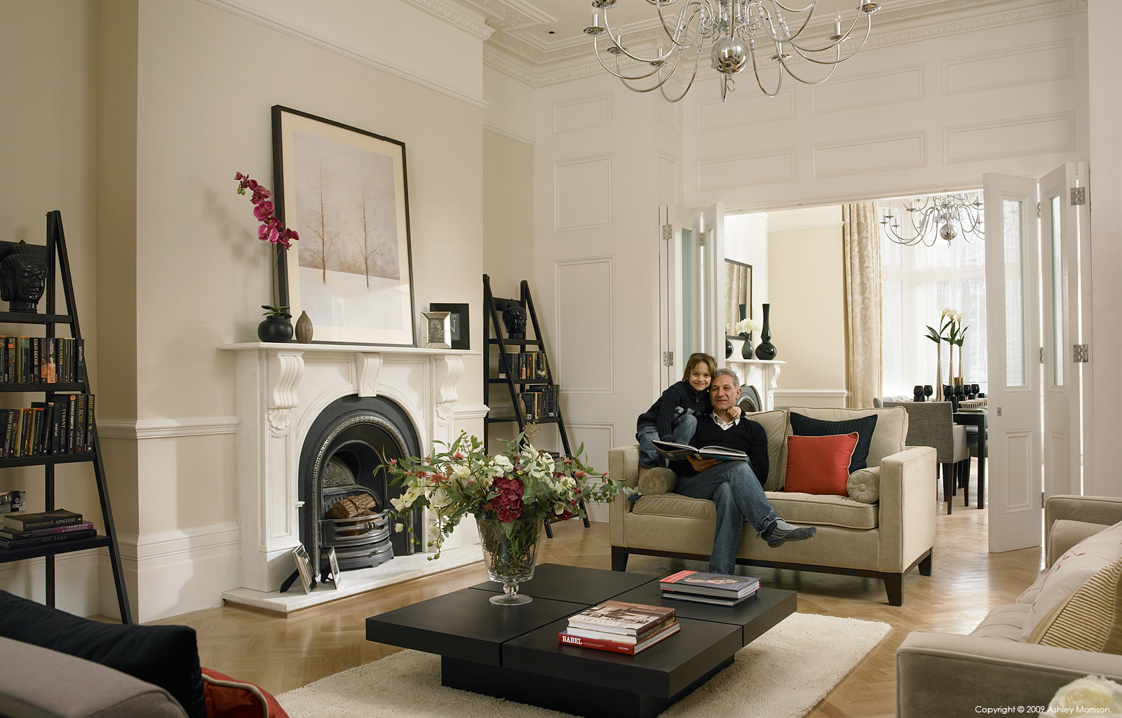 Kaveh Mobasheri & his son in the sitting room of their semi-detached house in the Camden area of London by Ashley Morrison.