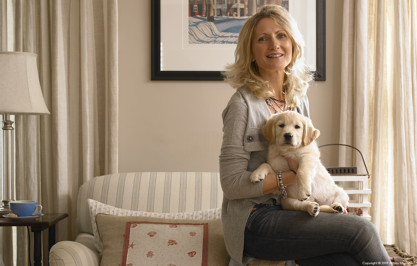 Sharon Cleland with her young puppy dog in the living room of her new-build house near Portstewart in County Londonderry.