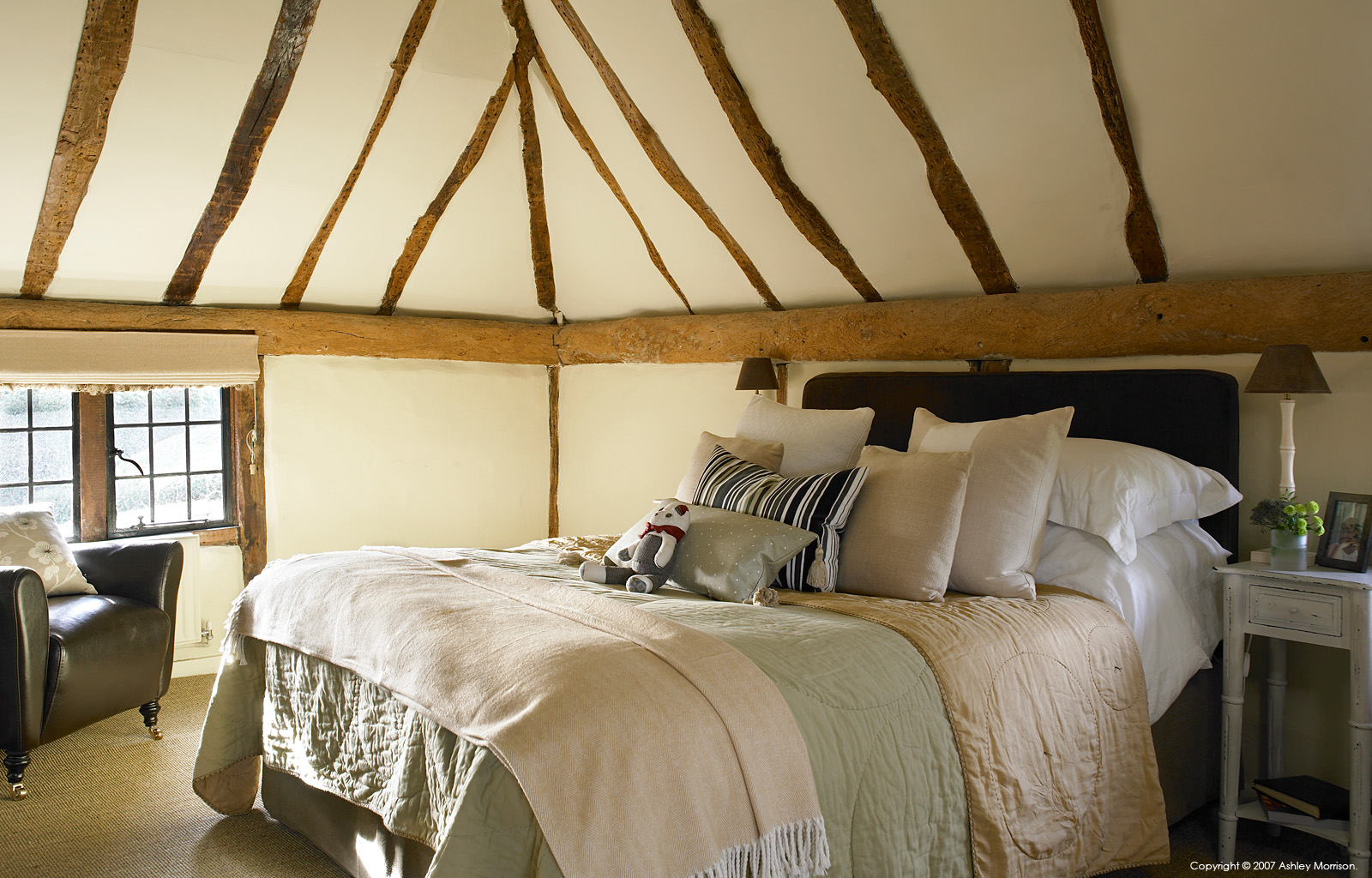 The master bedroom in Beth and Jason Cooper's 16th-century Barn style house near Guildford in Surrey.
