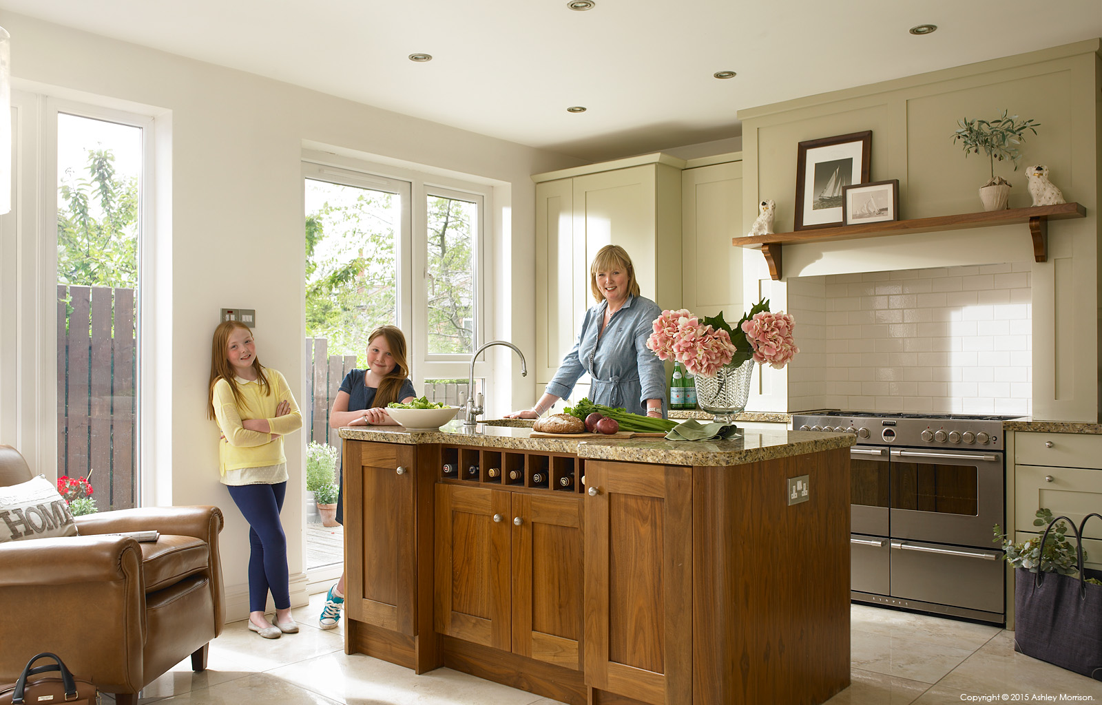 Lynne Doherty and her daughters in the kitchen of her 1940's semi-detached house in the Belmont area of Belfast.