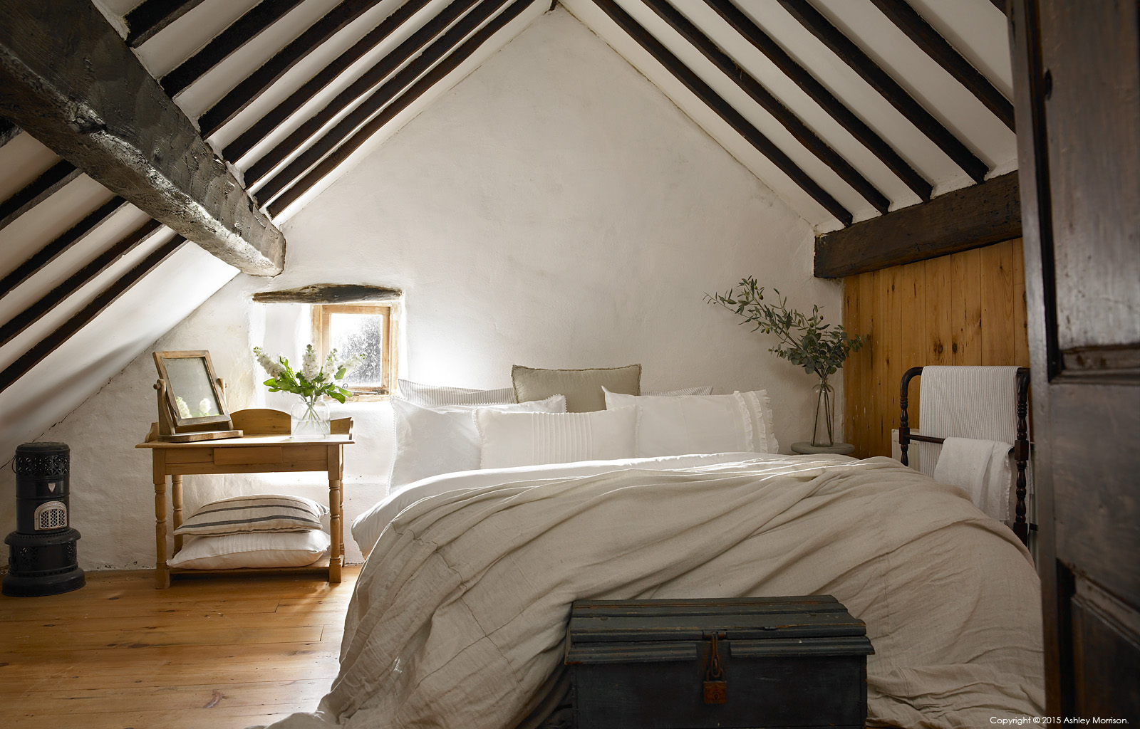 The master bedroom in Maggie and Robert Graham's 18th century Irish thatched cottage near the village of Kerrykeel in County Donegal.