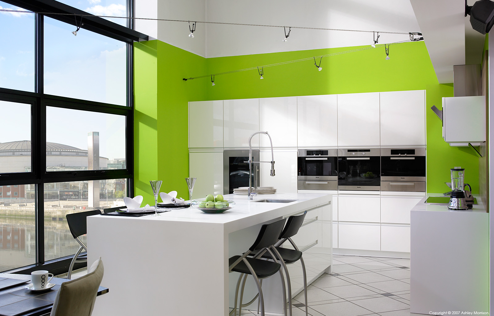 A Robinson Interiors High Gloss white kitchen overlooking Belfast Laganside by Ashley Morrison.